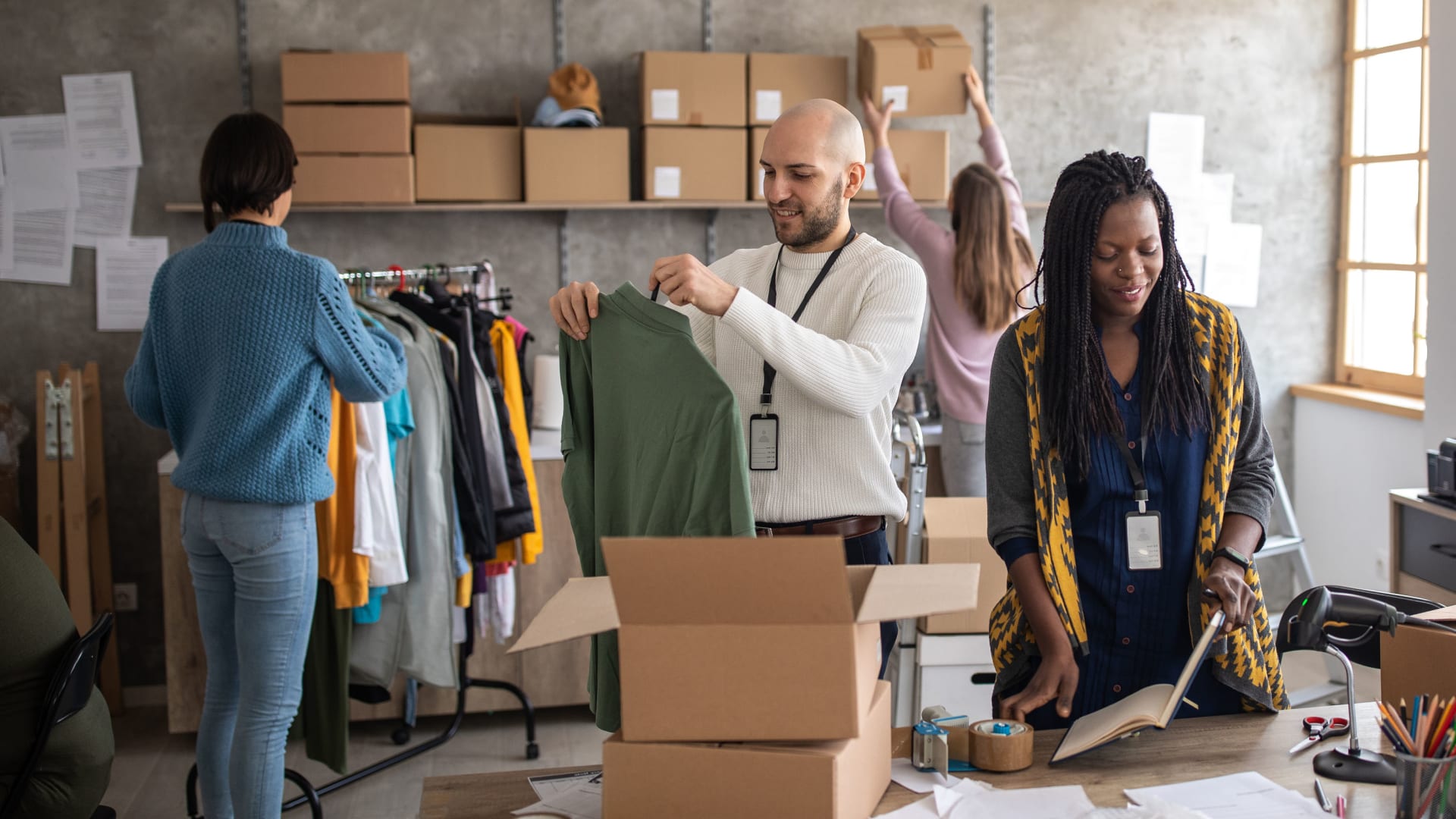 Retail workers packing boxes and shipping products