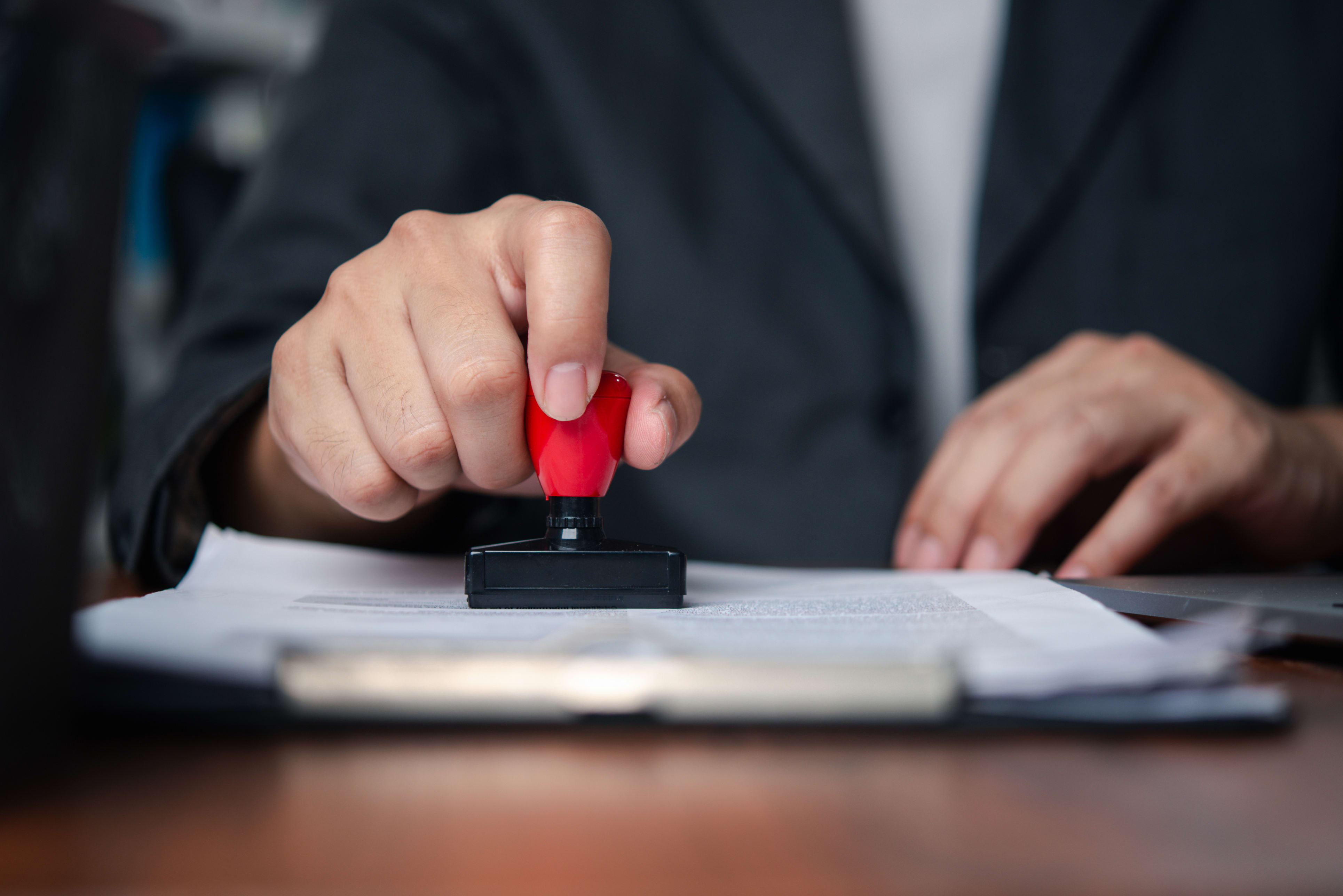 Person stamping to approve document