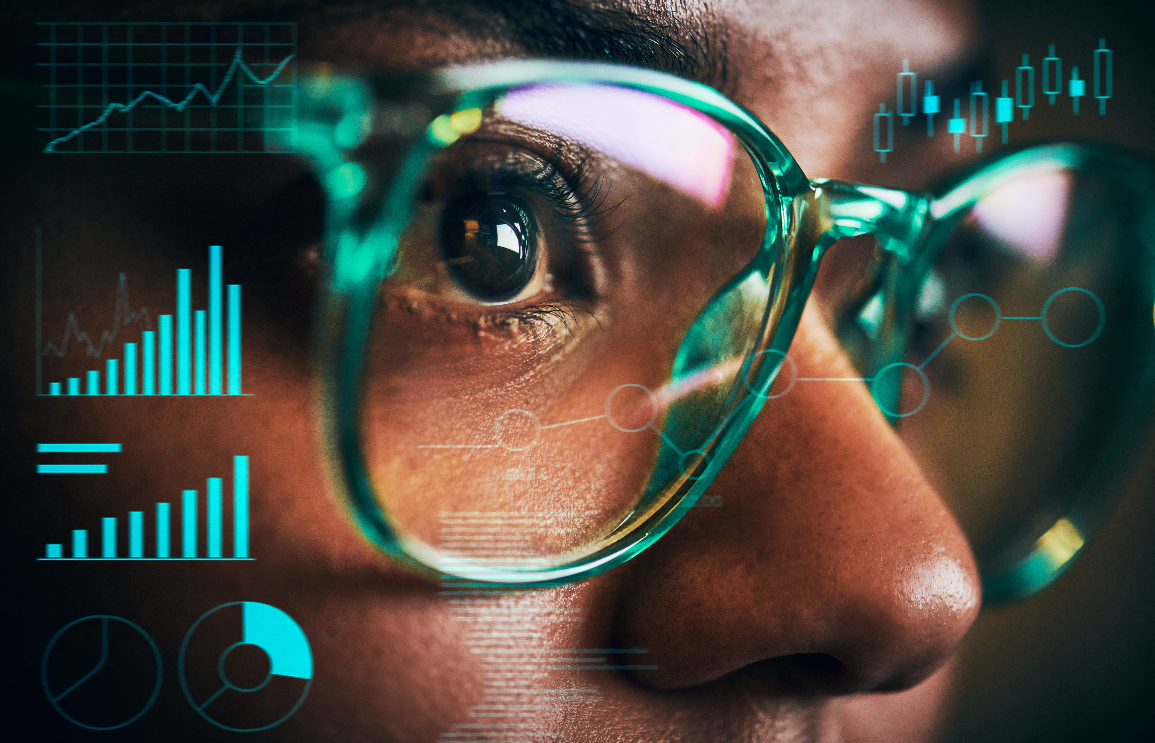 Close up of woman's eyes and glasses with floating digital graph overlays