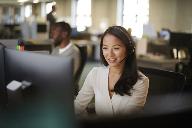 Customer service woman on call in front of computer