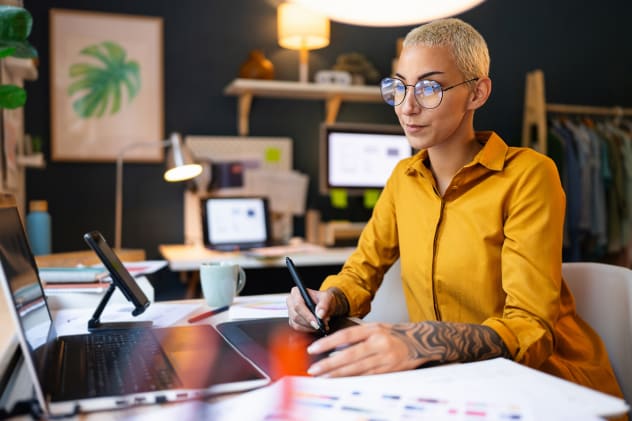 Young designer working with stylus on laptop