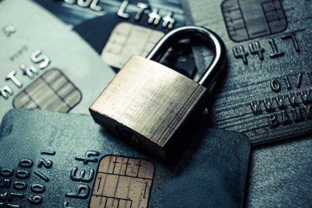 Padlock laying on a pile of credit cards