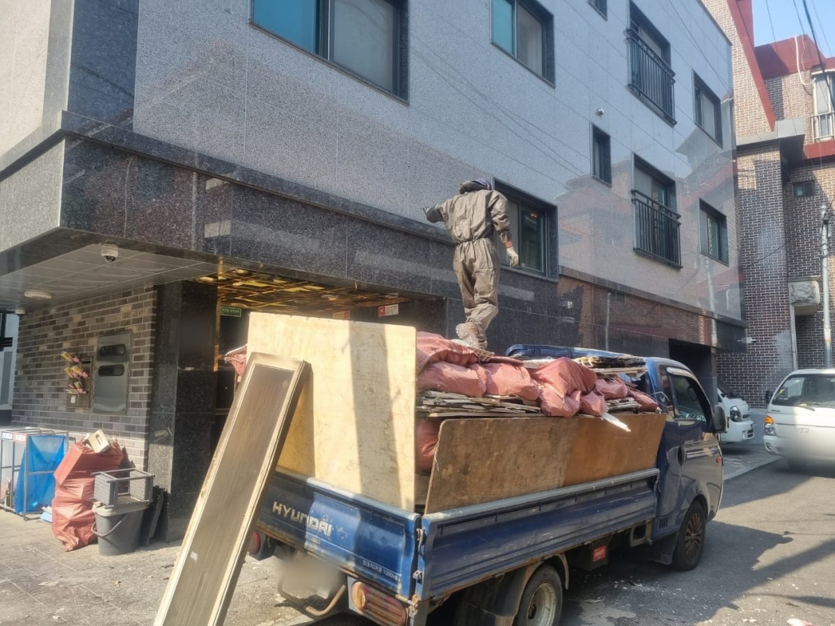 마대에 담아 내린 잔재물을 1톤 트럭에 싣는 모습