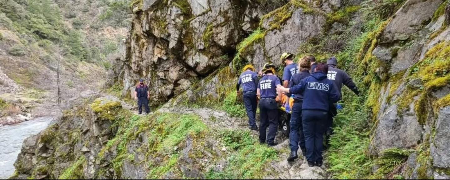 Crews carrying a patient out on a litter