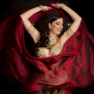 Belly dancers detail dancing with arabic music street band at the