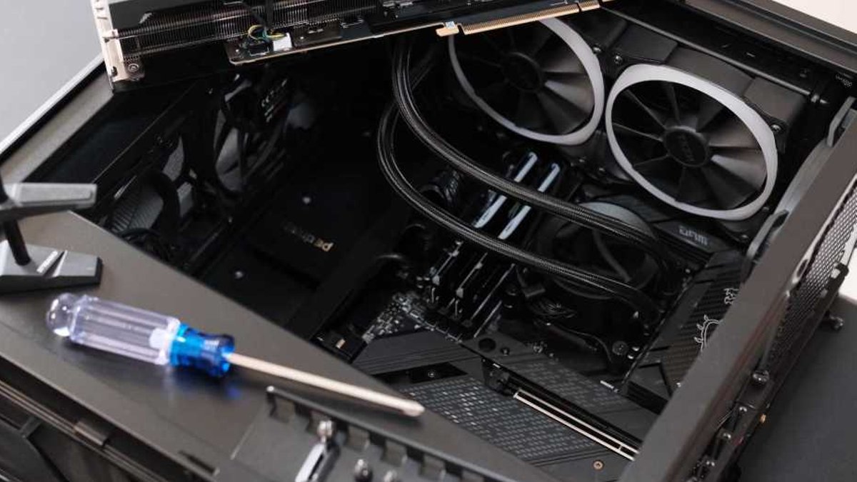 Experienced builder highlights essential PC assembly tools PC building - open computer case with parts still to be installed.