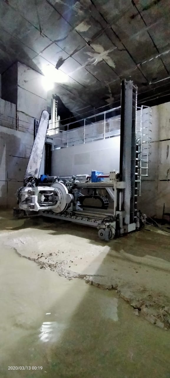 Chain saw machine on track inside the underground quarry