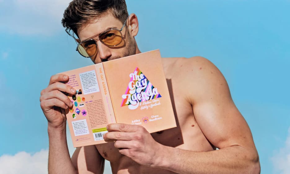 Man holding the Gay Agenda book