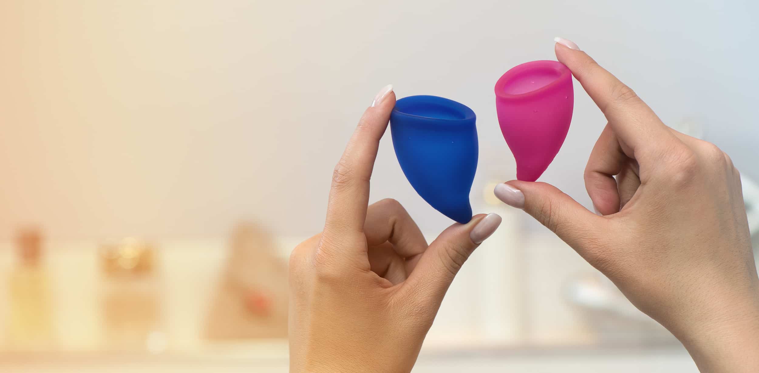 Hands holding two silicone cups