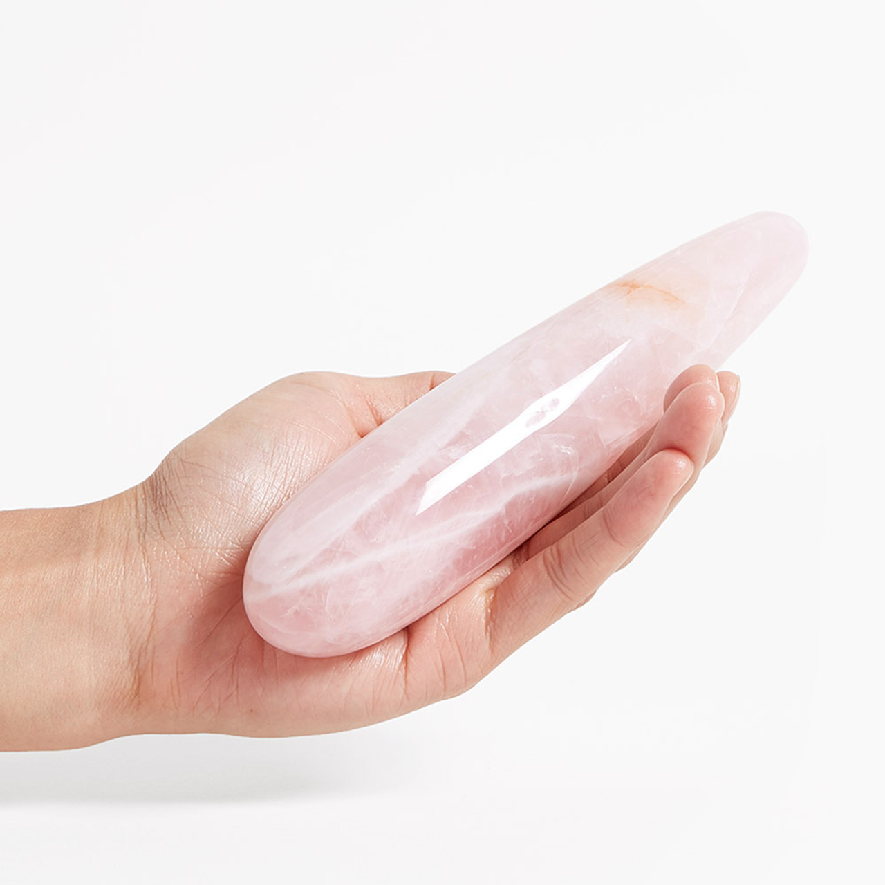Chakrubs The Original Heart Rose Quartz Dildo held in hand