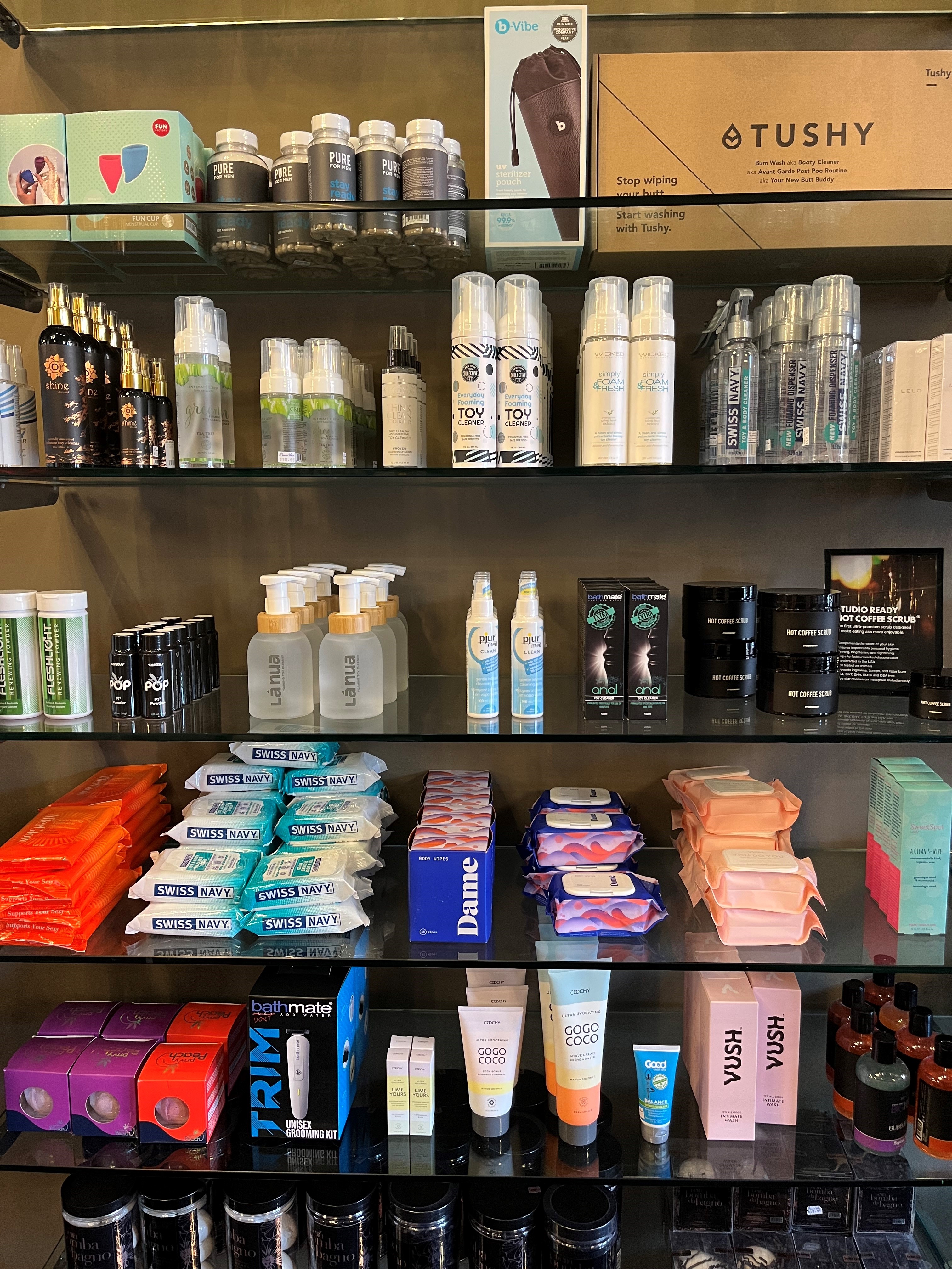 Toy cleaning products on glass shelves front facing