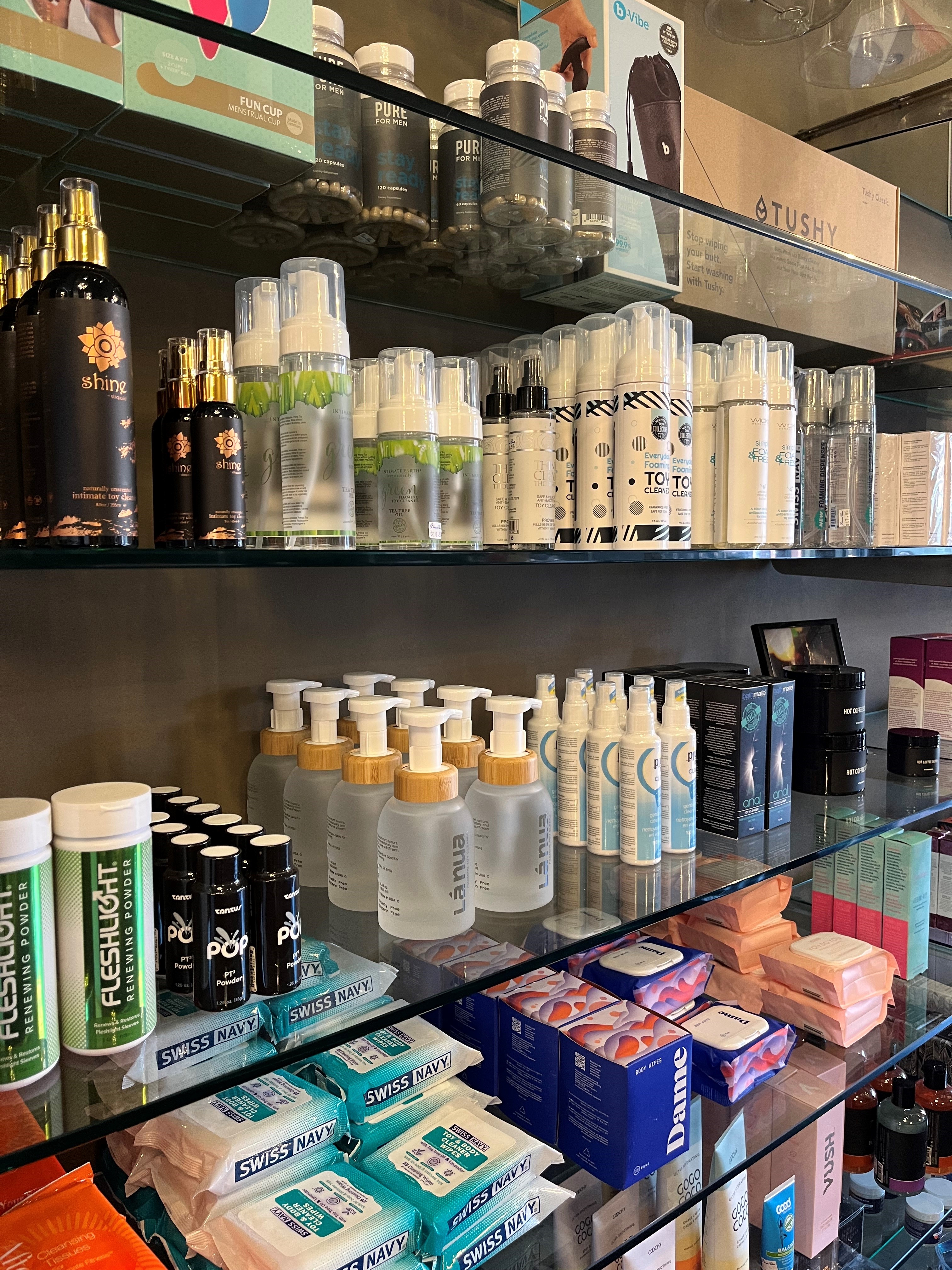 Toy cleaning products on glass shelves zoomed in from the side