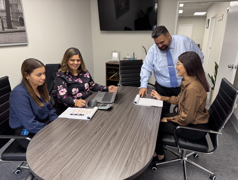 The Verma Tax and Accounting Solutions team meeting in the Smithtown, NY office