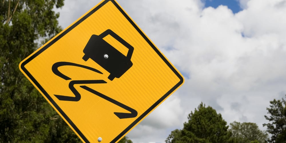 slippery road sign