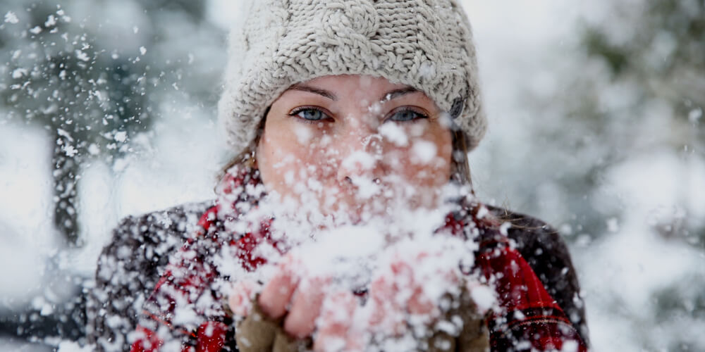 Girl blowing snow
