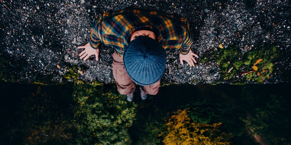 Man on a high stone wall