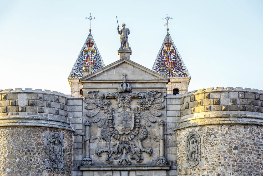 Detailed view of Bisagra gate with the coat of arms in Toledo, Spain