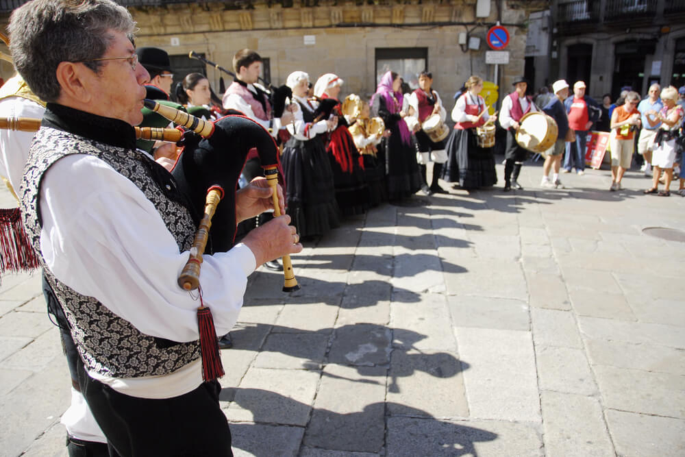 Bagpipers wearing traditional costumes in Santiago de Compostela.