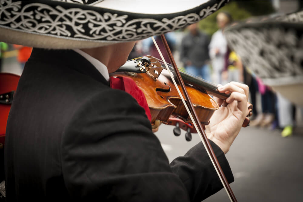 Mariachi musicians wear wide-rimmed sombreros