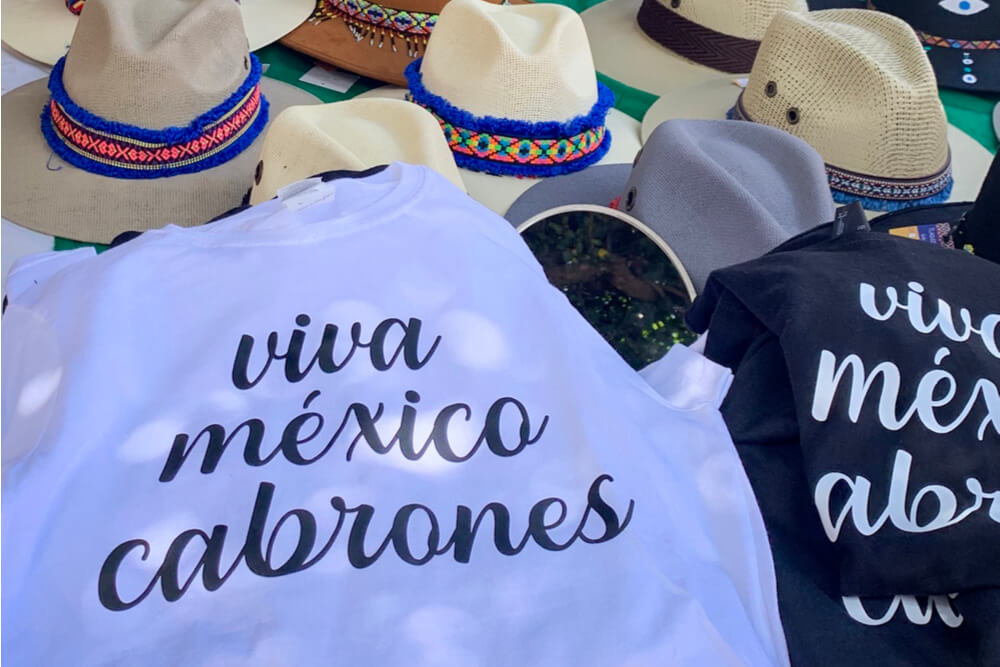 Viva Mexico, cabrones t-shirts on a stand