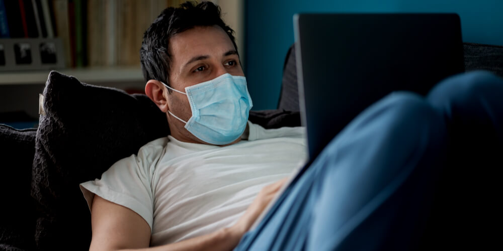 Man on a sofa in a mask