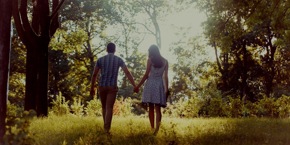 Happy couple walking in a forest