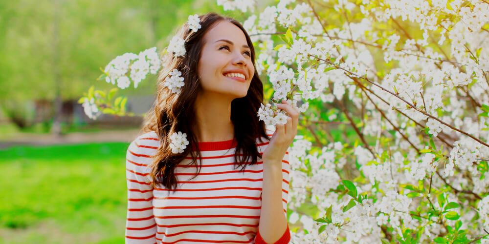 Beautiful girl near a Spring tree