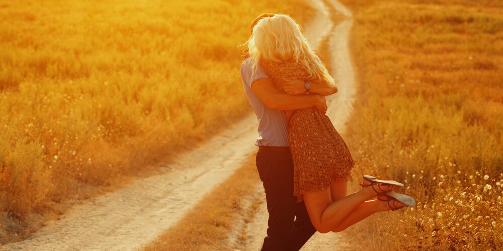 Couple embracing in a field