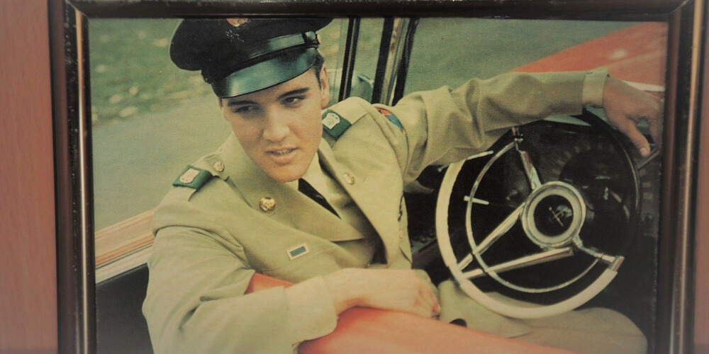 A framed picture of Elvis Presley in military uniform