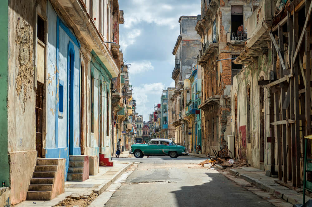 Havana Downtown with Local Unique Architecture and Old Vintage Car in Background