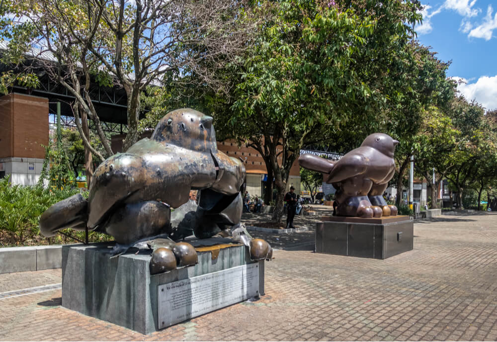 Botero bird sculpture destroyed by a bomb on a terrorist attack in 1995 at San Antonio Square sided with a new bird statue - Medellin, Antioquia, Colombia