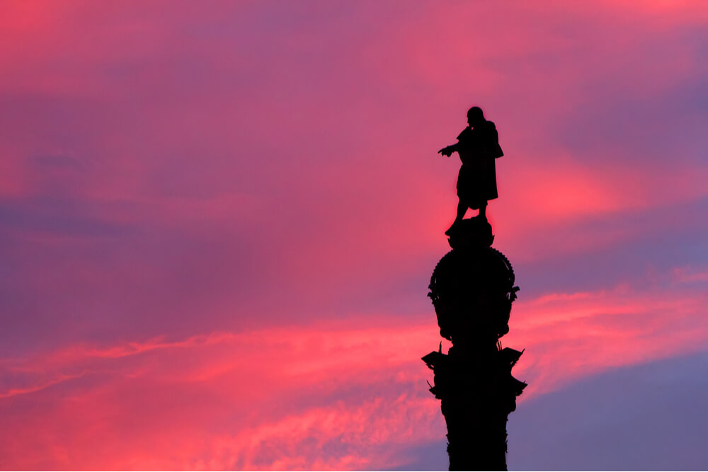 The silhouette of the Monument of Columbus at pink sunset in Barcelona, Spain