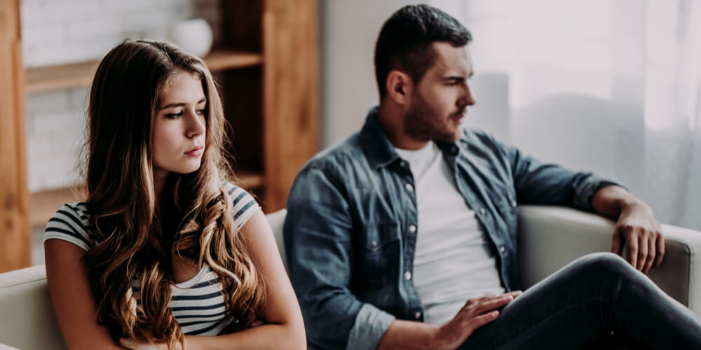 Unhappy couple sitting apart