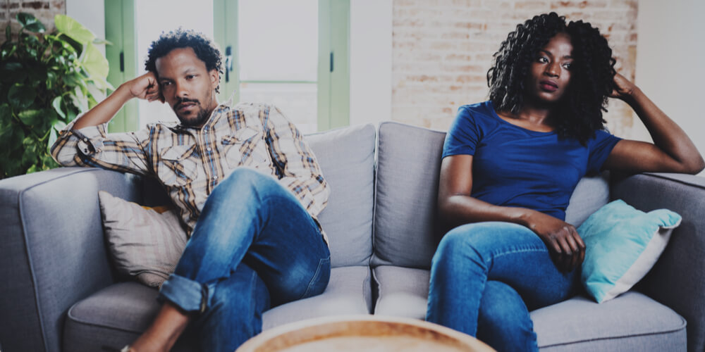 Unhappy couple sitting on a sofa