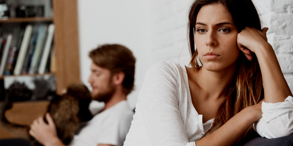 Unhappy woman with a man behind her