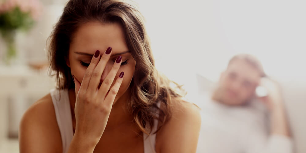 Woman closing her face with a palm