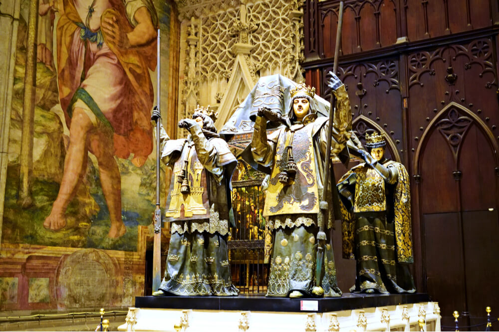 The tomb of Christopher Columbus carried by four heralds representing the four crowns of Spain located inside the Cathedral of Seville