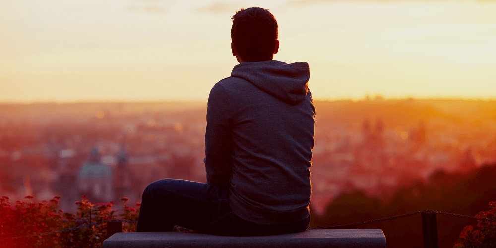 Man sitting alone looking into the distance