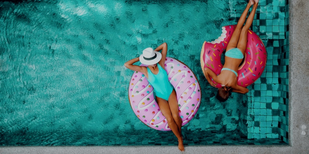 Two girls swimming in a pool