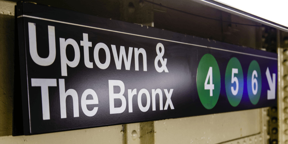 Sign in a New York subway station marking the way to Uptown & The Bronx trains