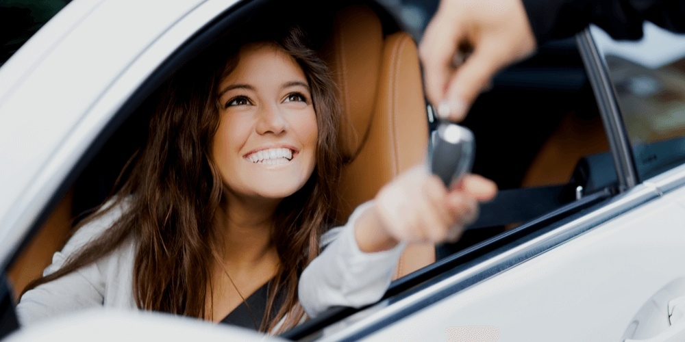 Happy woman getting a car key