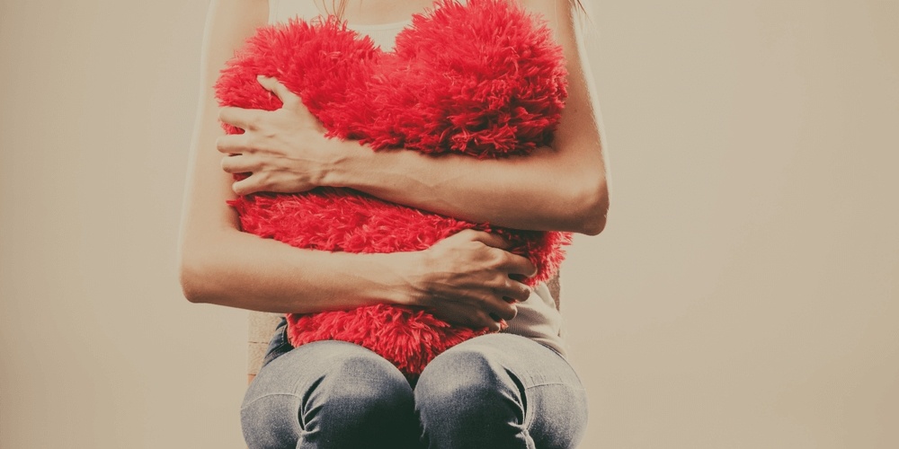 Girl embracing a red heart