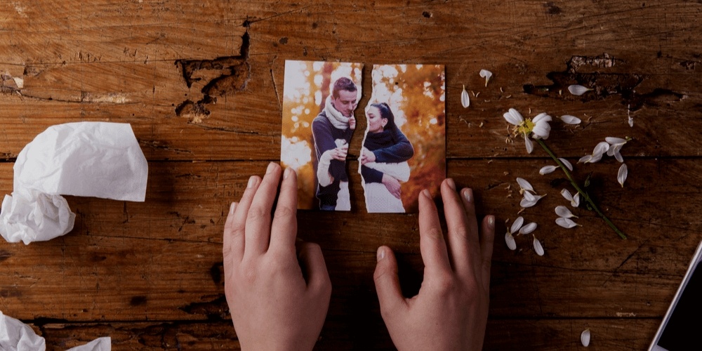 Tearing up a picture with a hppy couple