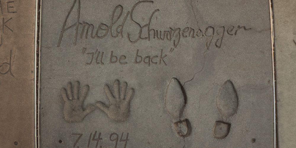 Arnold Schwarzenegger's handprints and footprints at the Grauman's Chinese Theatre, with the "I'll be back" catchphrase