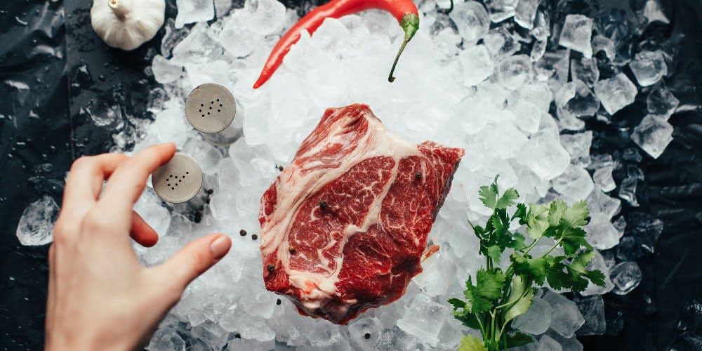 An Aries preparing to grill a steak.