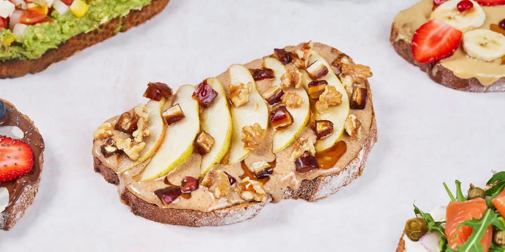 An easy and snackable toast, an Aquarius tops peanut butter and pears with walnuts.