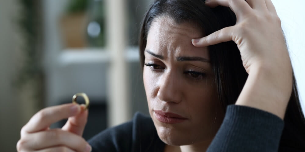 Girl crying over an engagement ring