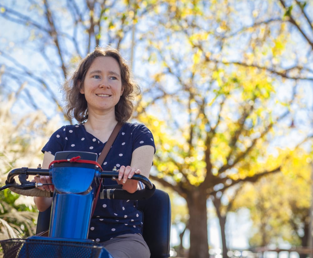 Lady smiling Lady on mobility scooter