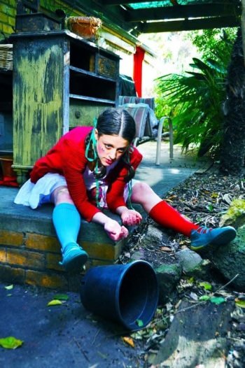 Girl sitting infront of pot