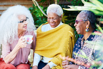 Three women talking and laughing